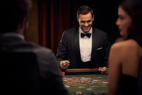 A woman in a luxurious green gown next to an ornate roulette wheel, capturing the upscale casino mood of HOKI678.