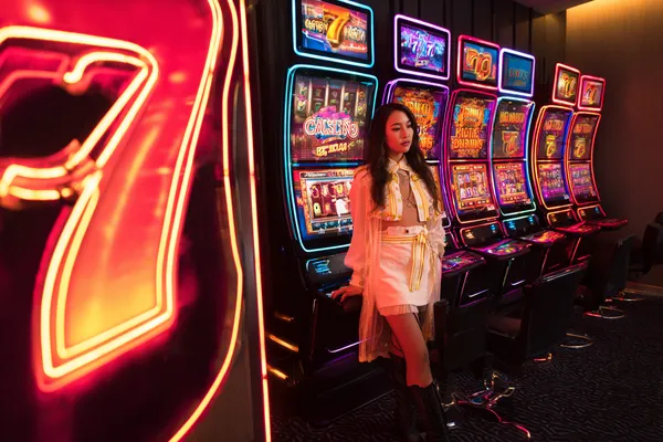 A confident dealer surrounded by casino chips inviting players to access their HOKI678 account, reflecting quick and easy login options.